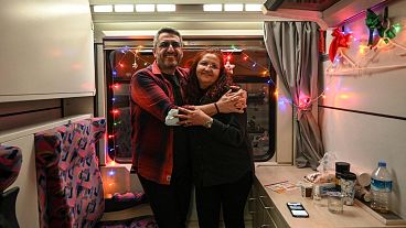 Passengers in their carriage decorated with lights and garlands