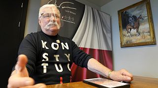 Poland's former president Lech Walesa wears a T-shirt reminding Poland's current right-wing government that it should respect the nation's constitution in his Gdansk office