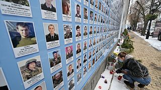 A relative of Ukrainian servicemen who died defending Donetsk airport, at a memorial wall for service personnel killed in the Russia-Ukraine conflict, Kyiv, January 21, 2022.