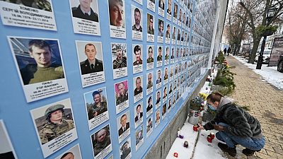 A relative of Ukrainian servicemen who died defending Donetsk airport, at a memorial wall for service personnel killed in the Russia-Ukraine conflict, Kyiv, January 21, 2022.