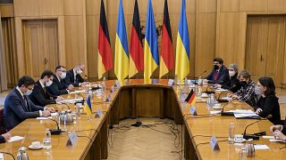 Ukrainian Foreign Minister Dmytro Kuleba, left, and German Foreign Minister Annalena Baerbock, right, attend talks in Kyiv, Ukraine, Monday, Jan. 17, 2022.