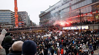 Protestors gather to demonstrate against the coronavirus measures including the vaccine pass, in Stockholm, Sweden, Saturday, Jan. 22, 2022.