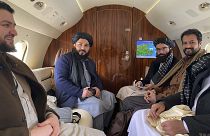 Taliban senior official member Anas Haqqani (R) and delegates sitting on a plane before departing to Oslo, at the Kabul airport in Kabul.