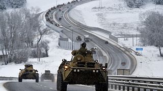 A convoy of Russian armoured vehicles moves along a highway in Crimea, Tuesday, Jan. 18, 2022.