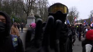 Protesters attack video team filming Belgian march against vaccinations and COVID-19 restrictions