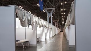 Makeshift hospital rooms stretch out along the floor at the Jacob Javits Convention Center in New York