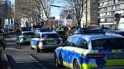 Police vehicles are parked on the grounds of Heidelberg University in Heidelberg, Germany, Monday, Jan. 24, 2022