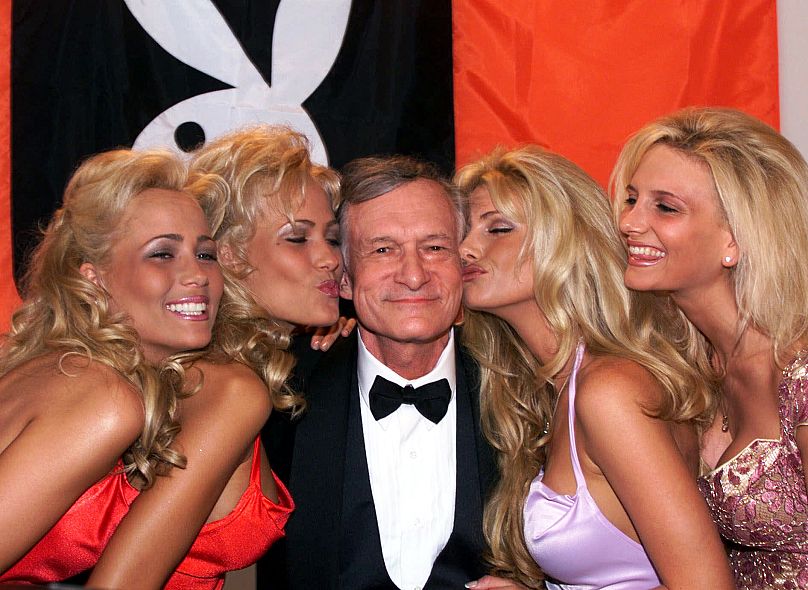 Hugh Hefner receives kisses from Playboy playmates during the 52nd Cannes Film Festival in Cannes, France in 1999