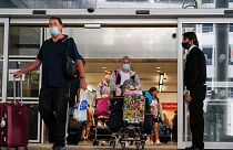 Passengers arrive at Gatwick Airport in London. This summer, no tests will be required from vaccinated travellers.