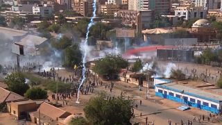 Tear gas canisters falling among protesters