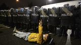 A protesters lies on the ground during a protest against new anti-abortion laws in Warsaw, Poland, Friday, Jan. 29, 2021