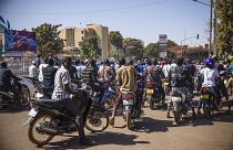 People cheer in support of putschist soldiers near the national television station in Ouagadougou, Monday, Jan. 24, 2022.