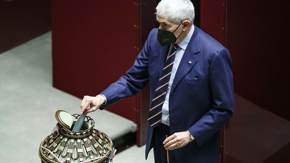 Lawmaker Pier Ferdinando Casini casts his ballot during the first round of votes in the Italian parliament, Monday, Jan. 24, 2022.