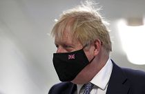 Britain's Prime Minister Boris Johnson wears a face mask, during a visit to Milton Keynes University Hospital in Buckinghamshire, England, Monday, Jan. 24, 2022.