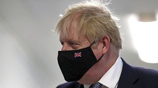 Britain's Prime Minister Boris Johnson wears a face mask, during a visit to Milton Keynes University Hospital in Buckinghamshire, England, Monday, Jan. 24, 2022.