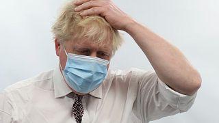 Britain's Prime Minister Boris Johnson gestures during a visit to Finchley Memorial Hospital, in North London, Tuesday, Jan. 18, 2022.