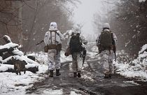 Ukrainian soldiers walks at the line of separation from pro-Russian rebels near Katerinivka, Donetsk region, Ukraine, 7 December 2021.