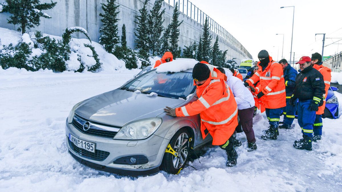 Δυνάμεις της πυροσβεστικής επιχειρούν να απεγκλωβίσουν όχημα από το χιόνι στην Αττική Οδό 