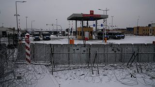 Polish checkpoint "Kuznitsa" is seen behind the barbed wire fence at the Belarus-Poland border near Grodno, Belarus, Dec. 23, 2021. 