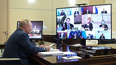 Russian President Vladimir Putin chairs a meeting with Italian businessmen via videoconference at the Novo-Ogaryovo residence outside Moscow, Russia, Wednesday, Jan. 26, 2022.