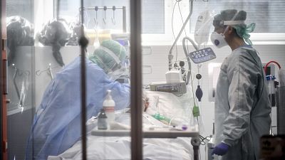 Medical personnel work in the intensive care unit of a hospital in Brescia, Italy early on in the pandemic, on 19 March 2020.