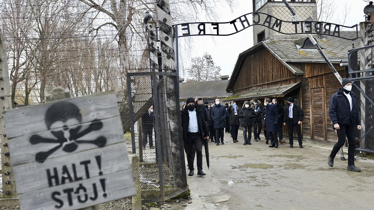 French PM Jean Castex stands at the gate during a visit at the Memorial and Museum Auschwitz-Birkenau of the former German Nazi concentration and extermination camp.
