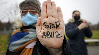  woman has "Stop Abuse" written on the palm of her hand during a protest dubbed "Save Me" in support of sexually abused children in Romania. File pic.