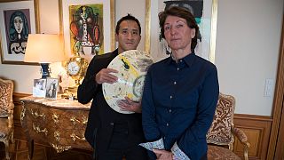 Marina Picasso, right, granddaughter of artist Pablo Picasso, and her son Florian Picasso pose with a ceramic art-work of Pablo Picasso that is NOT going on sale as NFTs