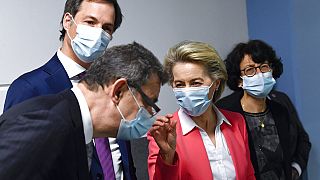  European Commission President Ursula von der Leyen, second right, speaks with Pfizer CEO Albert Bourla, left, and Belgium's Prime Minister Alexander De Croo, second left.