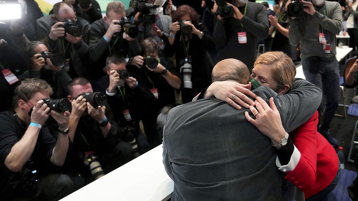 Omid Nouripour, newly elected party's co-chairman, is hugged by his wife Melanie Schnatsmeyer during a virtual party convention of the German Greens in Berlin