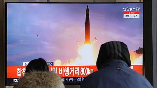 People watch a TV showing a file image of North Korea's missile launch during a news program at the Seoul Railway Station in Seoul, South Korea