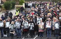 People take part in a march to commemorate the 50th anniversary of the 'Bloody Sunday' shootings with the photographs of some of the victims in Londonderry, Sunday