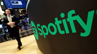 A trading post sports the Spotify logo on the floor of the New York Stock Exchange.
