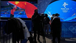 Foreign journalists cover a rehearsal of a victory ceremony at the Winter Olympics in Beijing, China. 3 January 2022