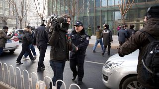 Başkent Pekin'de bir yabancı gazetecinin görüntü almasını engellemeye çalışan Çin polisi (arşiv)