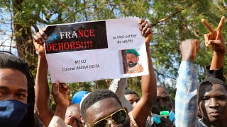 Thousands join a government-sponsored rally in Mali's capital Bamako Jan. 14, 2021 to protest new regional economic sanctions and growing pressure from France.