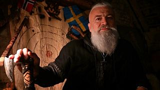 Stipe Pleic, also known by his Viking nickname of Ragnar Kavurson, poses in front of a display of the weapons he has created in the western-Bosnian town of Tomislavgrad