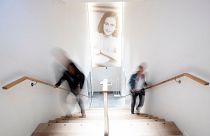 People walk up the stairs at the renovated Anne Frank House Museum in Amsterdam, Netherlands