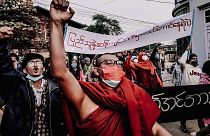 A Buddhist monk raises his clenched fist while marching during an anti-military government protest rally on Tuesday, Feb. 1, 2022, in Mandalay, Myanmar.