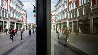 People walk along an empty Grafton Street in Dublin