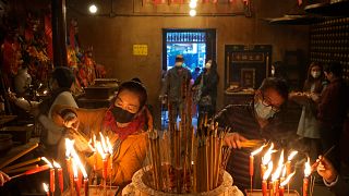 Monks ring temple bell for Lunar New Year