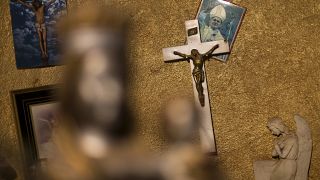 Crosses and an image of Pope John Paul II hang inside a Church, on the outskirts of Madrid.