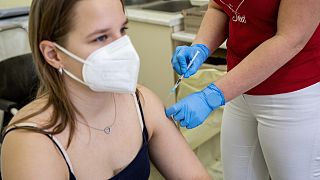 2022. február 1. Somogyi Nóra asszisztens beolt egy nőt a Pfizer-BioNTech koronavírus elleni oltóanyag, a Comirnaty-vakcina harmadik, emlékeztető adagjával olt be