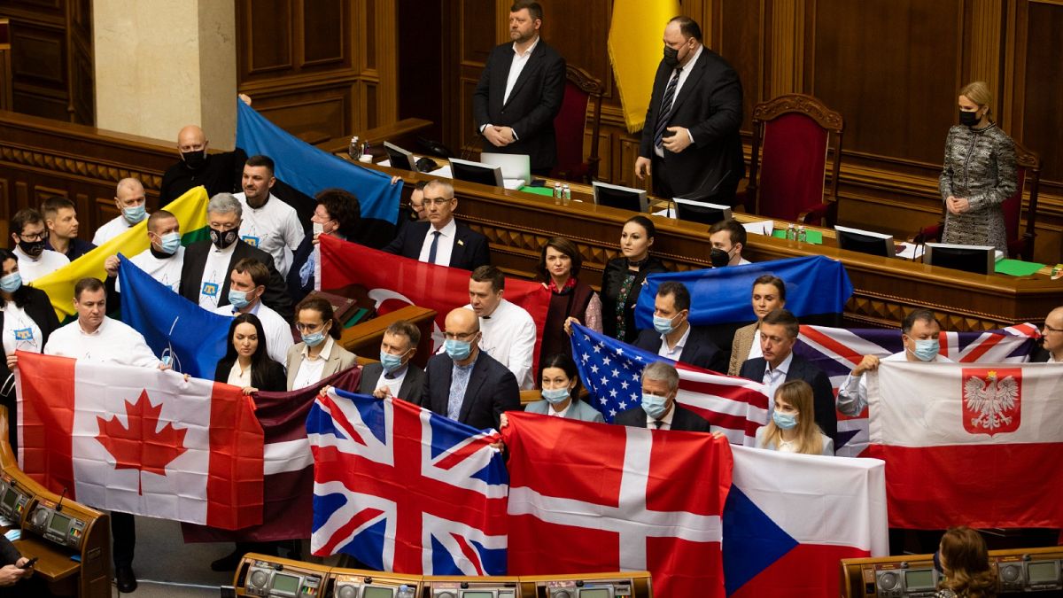 Ukrainian MPs hold flags of various countries to thank them for support shown amid the Russia border crisis.