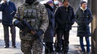 Relatives of arrested after anti-government protests gather near a police station in Almaty.