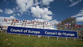 A view of European flags floating in front of the Council of Europe building in Strasbourg.