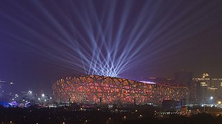 Lights shine during a rehearsal for the opening ceremony of the 2022 Winter Olympics at the National Stadium in Beijing