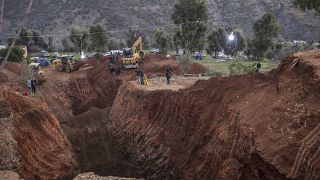 Civil defense and local authorities dig in an attempt to rescue the boy near the town of Bab Berred.