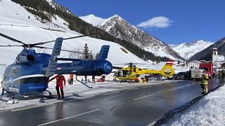 Rescue helicopters stand on a street near the Gammerspitze after an avalanche killed one person on February 4, 2022.