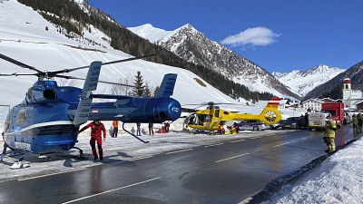 Rescue helicopters stand on a street near the Gammerspitze after an avalanche killed one person on February 4, 2022.
